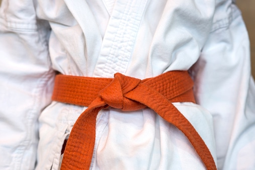Close-up view of karate orange belt of a young kid Orange Belt